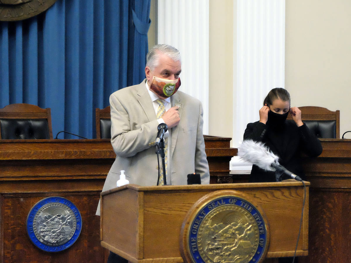 Gov. Steve Sisolak prepares to begin a press briefing at the Capitol Monday on the state's new ...