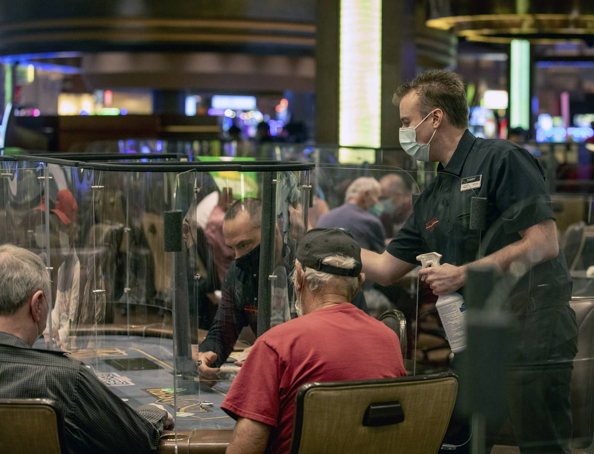 An eight-handed game is played using plexiglass dividers between the players in the Red Rock Re ...