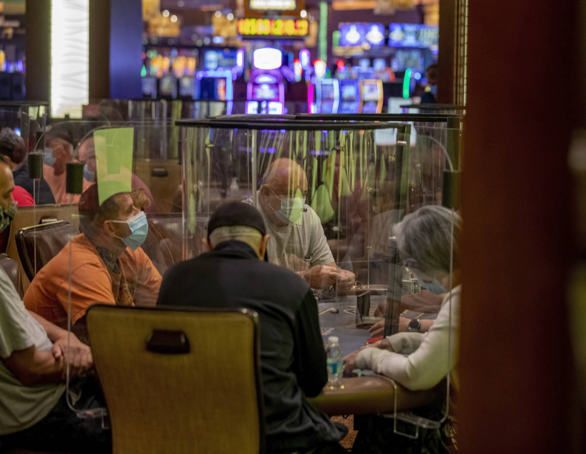 An eight-handed game is played using plexiglass dividers between the players in the Red Rock Re ...