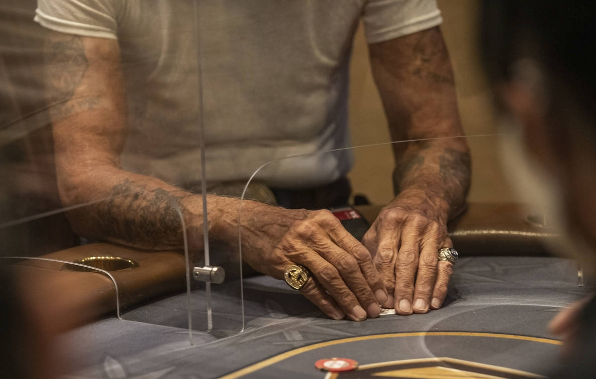 An eight-handed game is played using plexiglass dividers between the players in the Red Rock Re ...