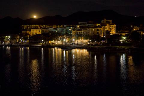 The Sturgeon moon rises above the shops at Lake Las Vegas on Monday, August 3, 2020, in Henders ...