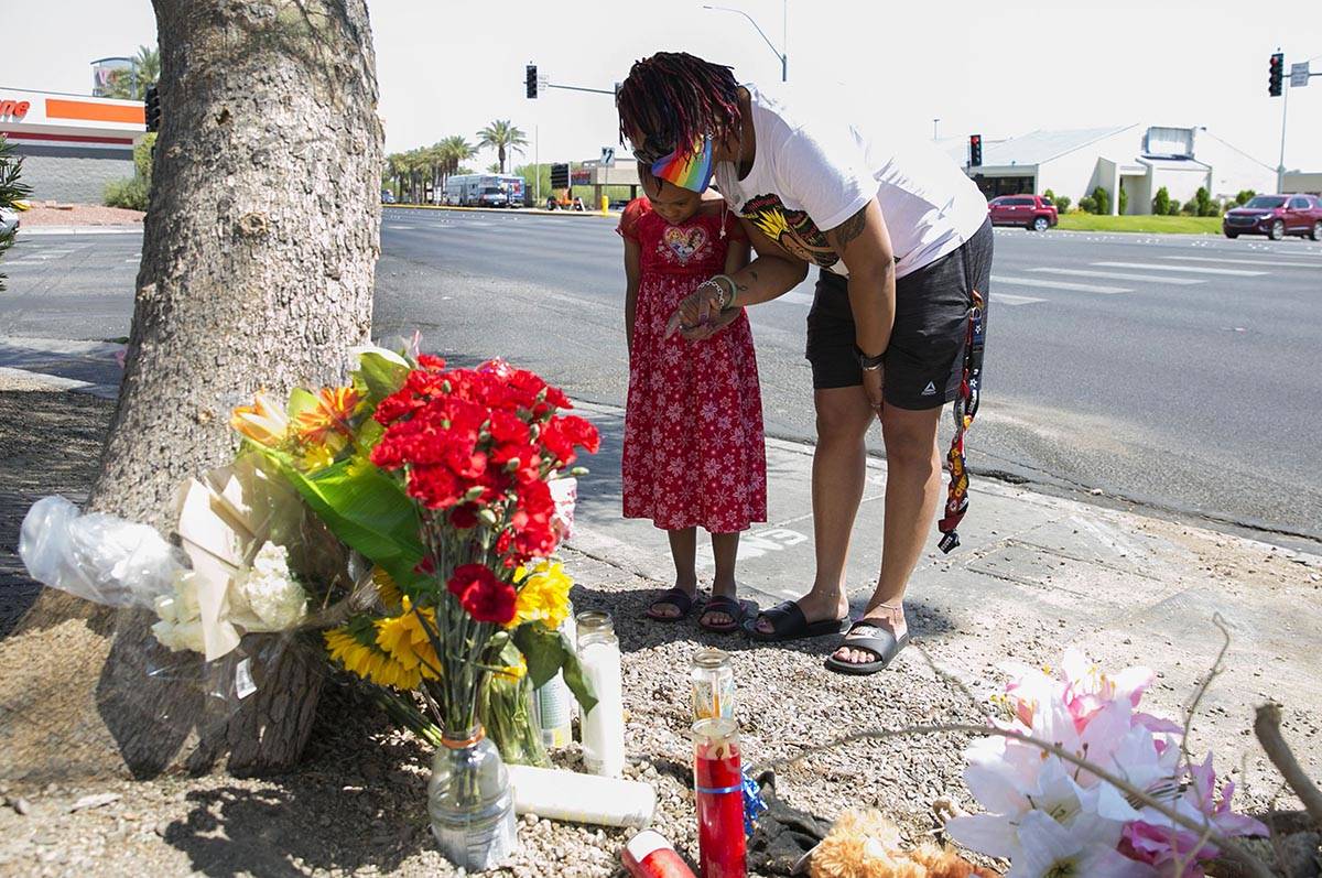 Tiffany Joseph and her daughter Jordan, 6, visit a makeshift roadside memorial on Wednesday, Au ...