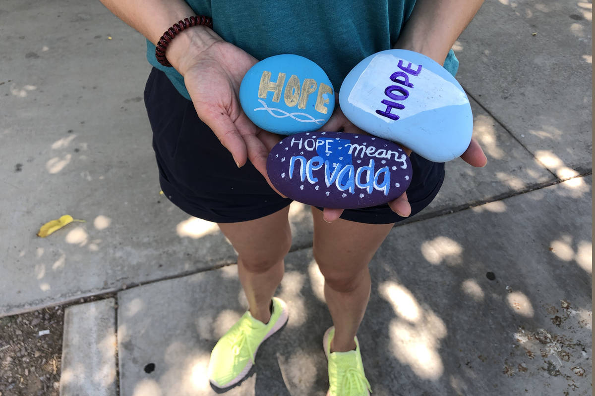 Angela Edgeworth holds rocks in Lorenzi Park in Las Vegas,Tuesday, Aug. 4, 2020. Edgeworth sist ...