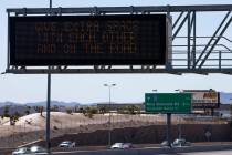 A Nevada Department of Transportation sign sends a message of traffic safety and COVID-19 socia ...