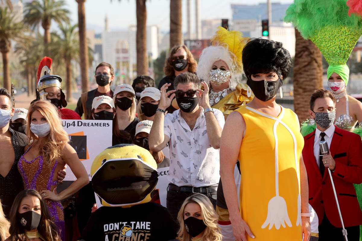 Las Vegas Review-Journal columnist John Katsilometes, center, poses with entertainers at the We ...
