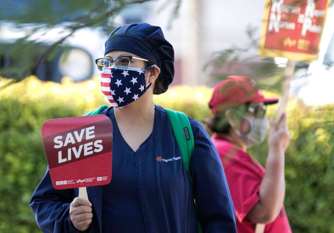 Registered Nurse Kady, who declined to give her last name, pickets outside St. Rose Siena Hospi ...