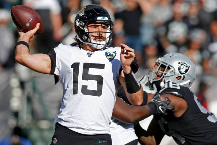 Jacksonville Jaguars quarterback Gardner Minshew throws the ball as Oakland Raiders defensive e ...