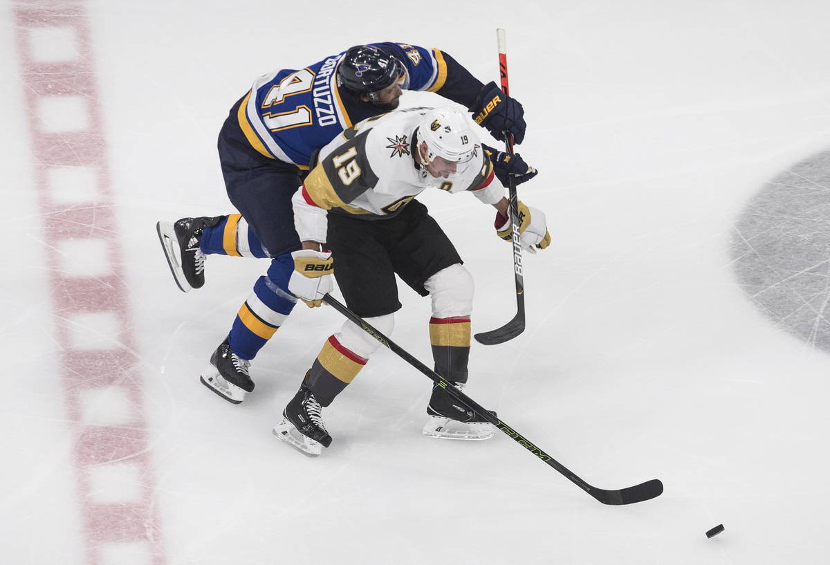 St. Louis Blues' Robert Bortuzzo (41) and Vegas Golden Knights Reilly Smith (19) battle for the ...