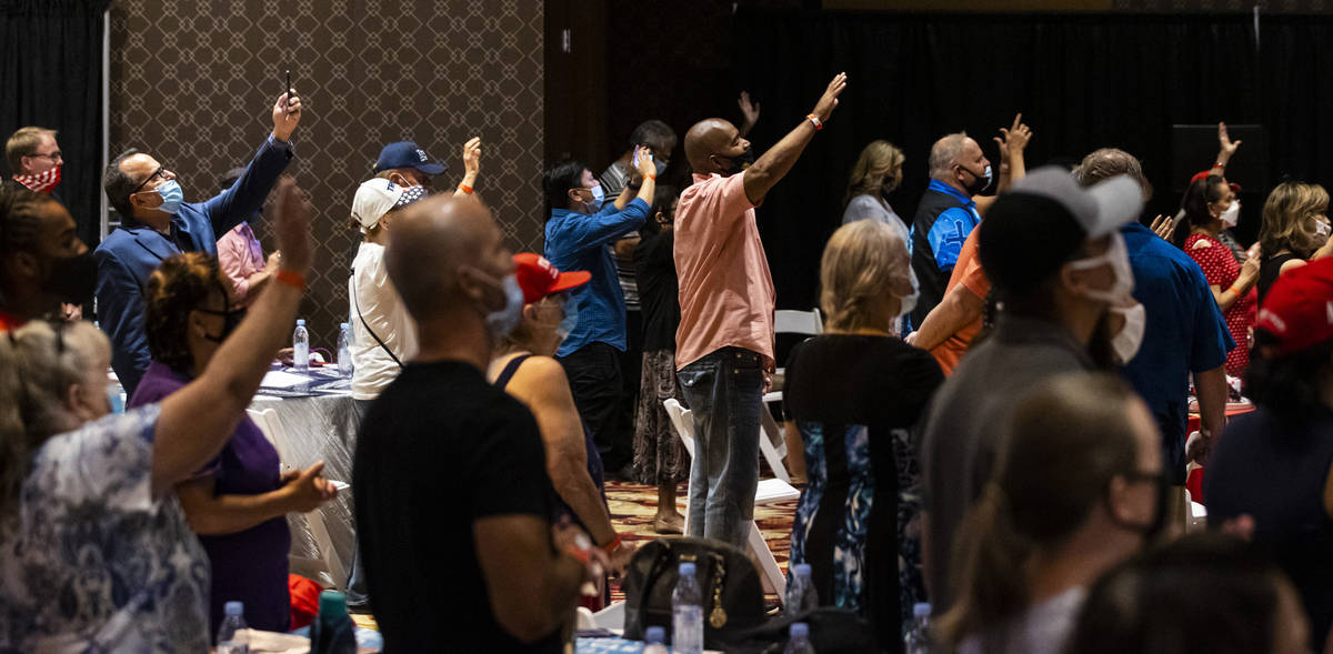 People react as a song is performed during an "Evangelicals for Trump" campaign event ...