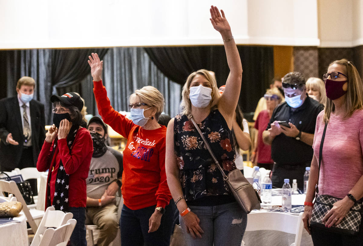People react as a song is performed during an "Evangelicals for Trump" campaign event ...