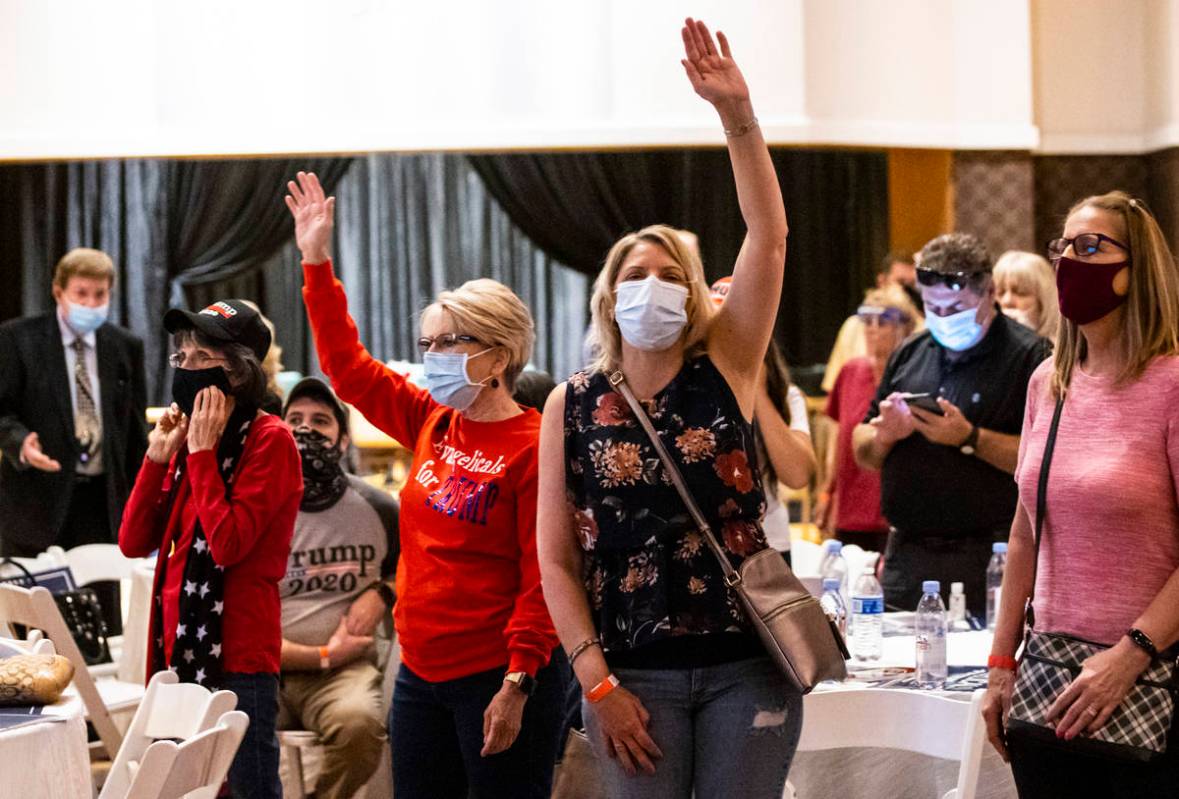 People react as a song is performed during an "Evangelicals for Trump" campaign event ...