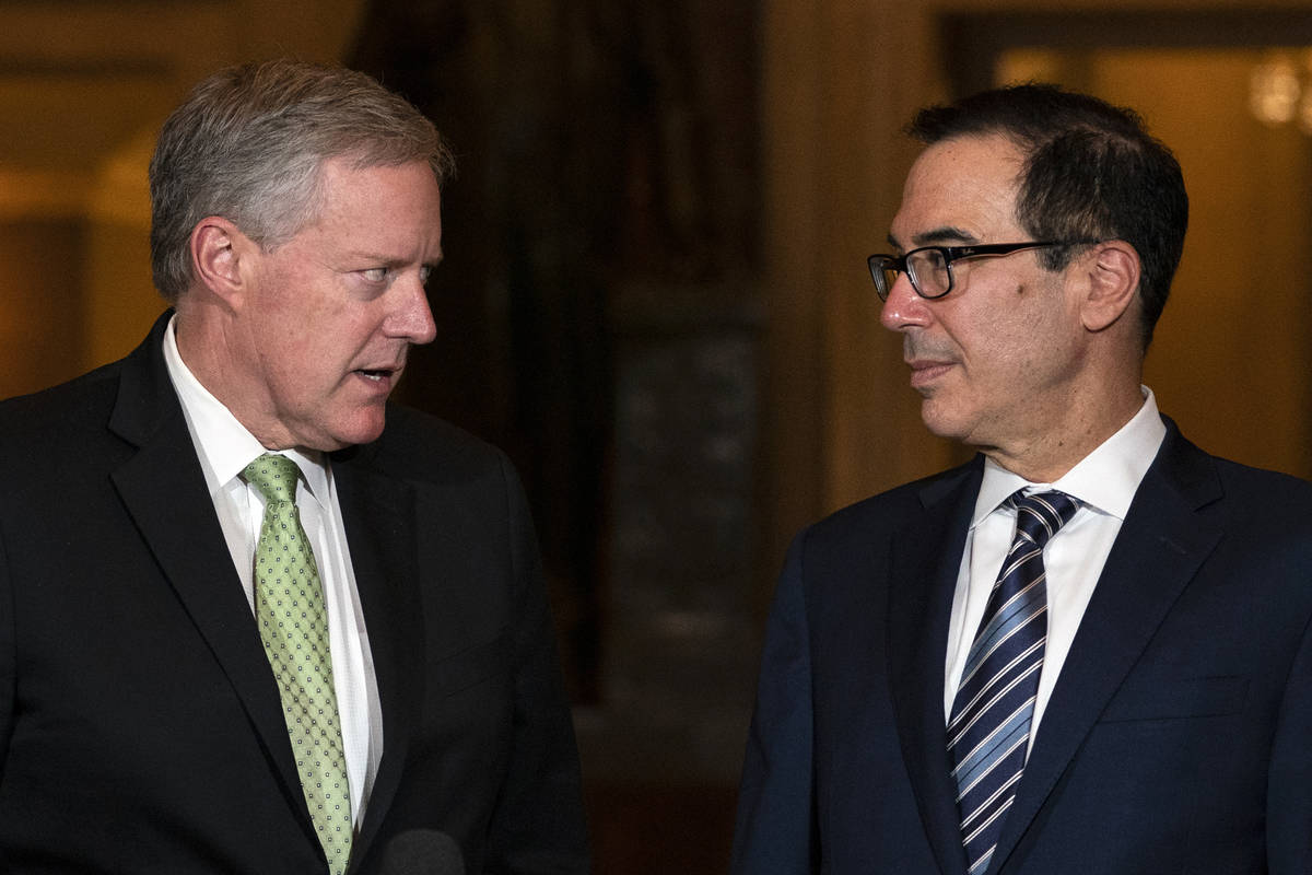 Treasury Secretary Steven Mnuchin and White House chief of staff Mark Meadows look to each othe ...