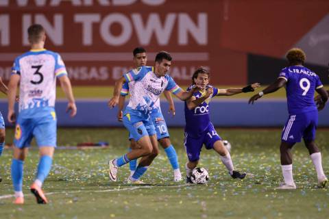 Mart’n Del Campo, center left, battles for the ball against Reno 1868 FC's Emilio Ycaza durin ...