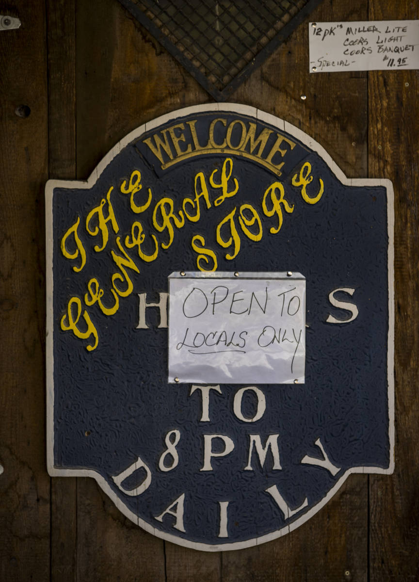 A sign on the door of The General Store notes they are "Open to locals only" in Goldfield on Tu ...