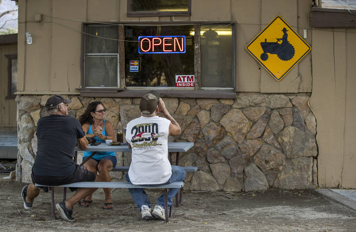 (From left) Hugh and Deb Burton join friend Kevin Goss for a drink while outside of The Boonies ...