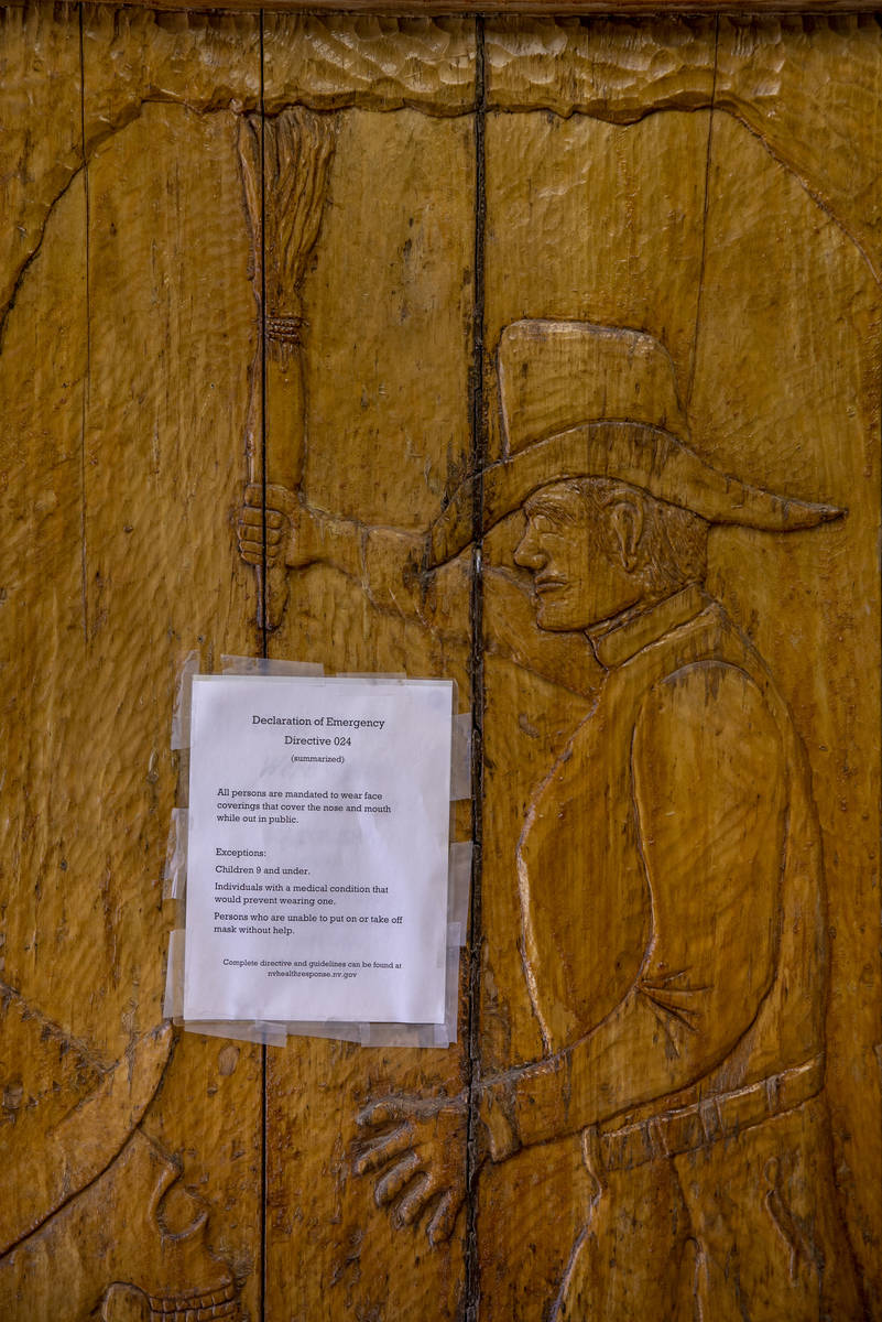 A carved wooden door by owner Bryan Smalley of the Hidden Treasure Trading Co. displays a face ...