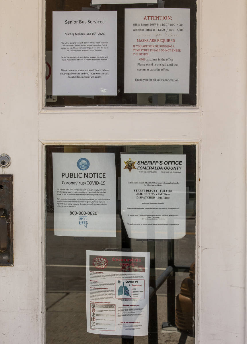 Numerous COVID19 notices are taped to the front windows at the