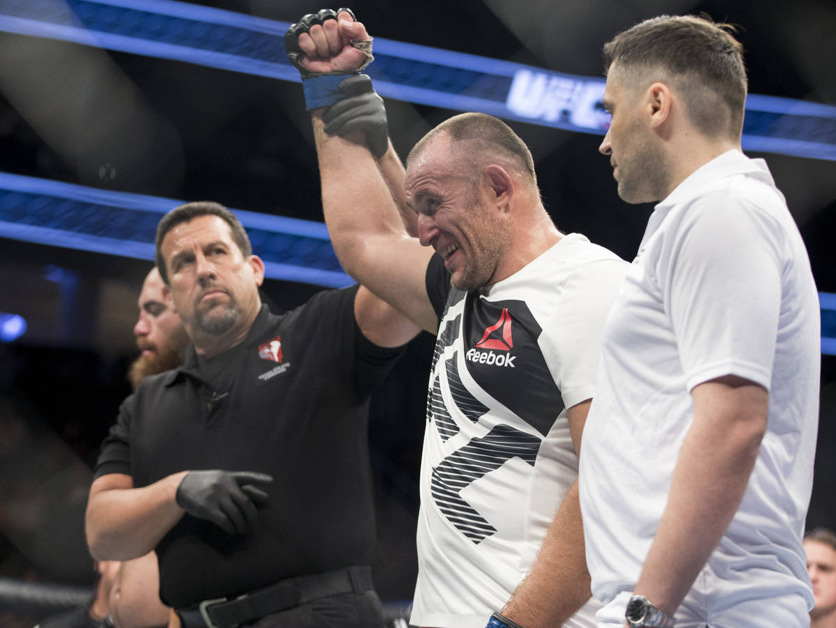 Aleksei Oleinik, right, is announced the winner by way of submission against Travis Browne in ...