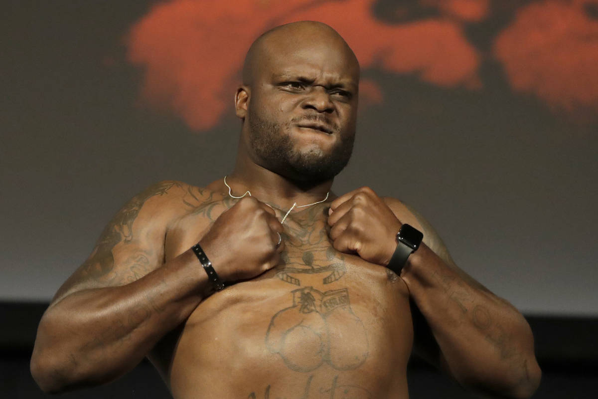 Derrick Lewis reacts while posing atop a scale prior to his heavyweight mixed martial arts bout ...