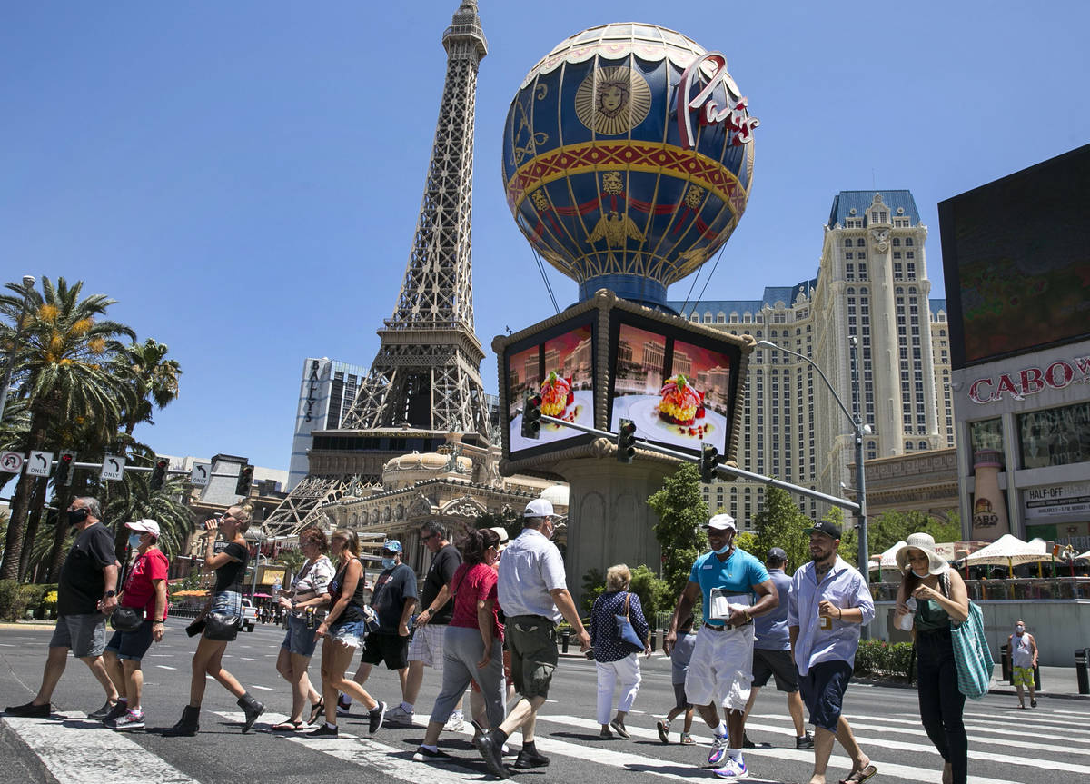 Tourists cross Las Vegas Boulevard near Paris Las Vegas, July 3, 2020. (Bizuayehu Tesfaye/Las V ...
