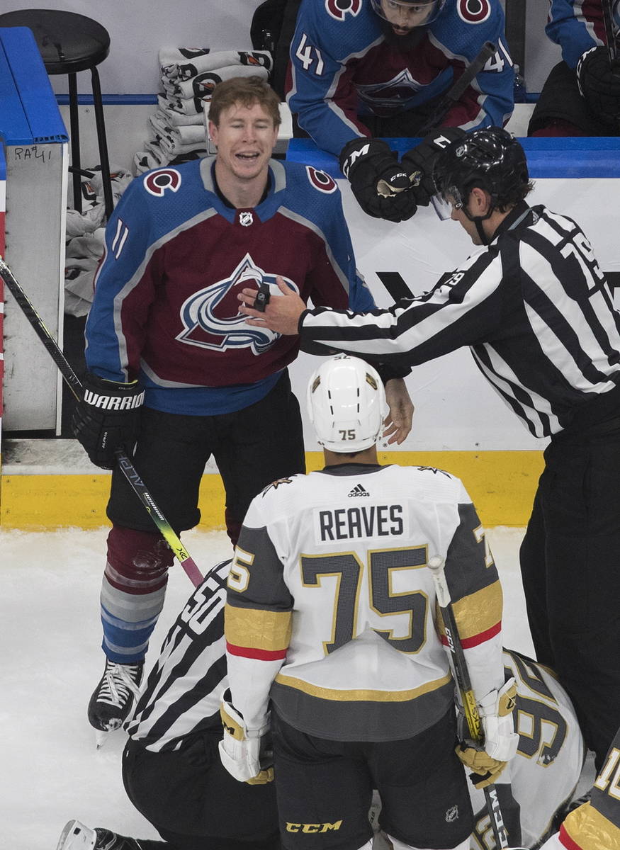 Colorado Avalanche's Matt Calvert (11) and Vegas Golden Knights' Ryan Reaves (75) exchange word ...