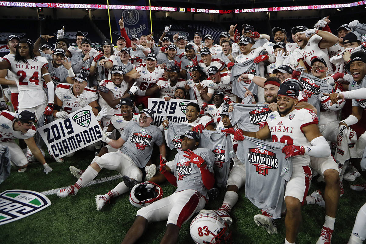 FILE - In this Dec. 7, 2019, file photo, members of the Miami of Ohio team pose on the field af ...