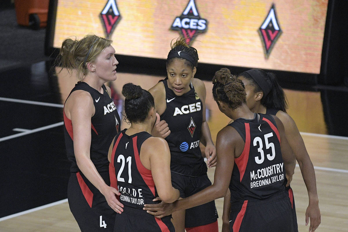 Las Vegas Aces players huddle on the court during the second half of a WNBA basketball game aga ...