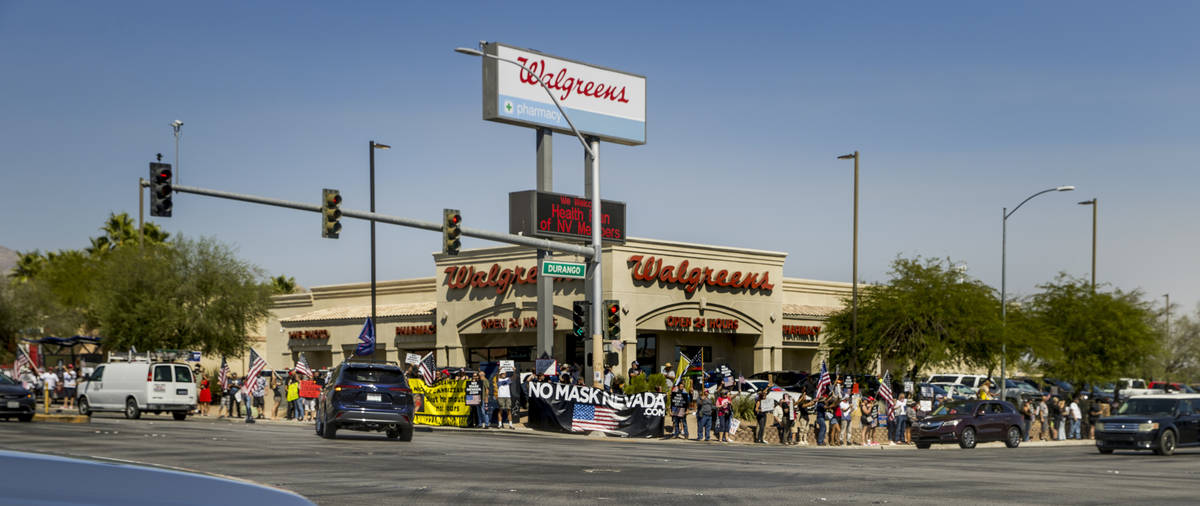 Supporters line the sidewalks during a No Mask Nevada rally to oppose the face mask mandate and ...