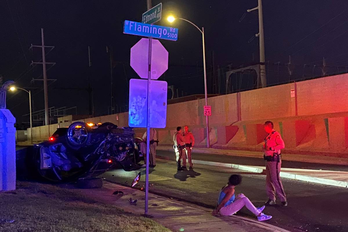 Las Vegas police investigate a rollover crash at the intersection of West Flamingo Road and Edm ...