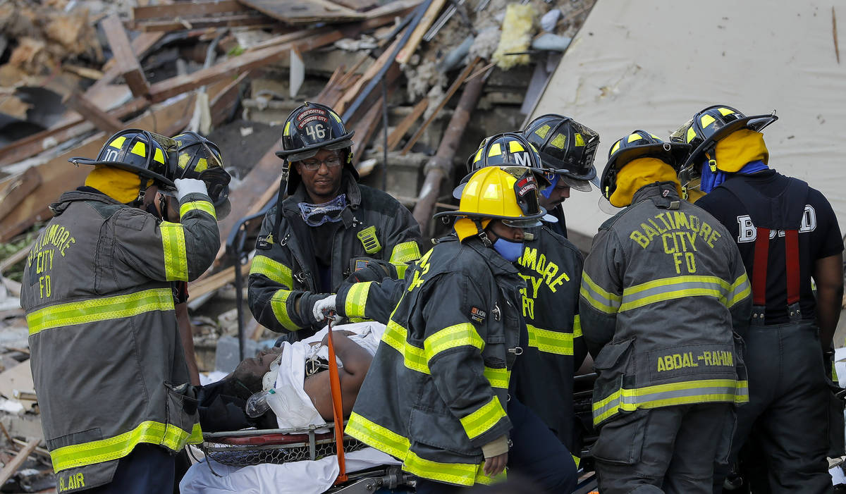Baltimore City Fire Department carries a person out from the debris after an explosion in Balti ...