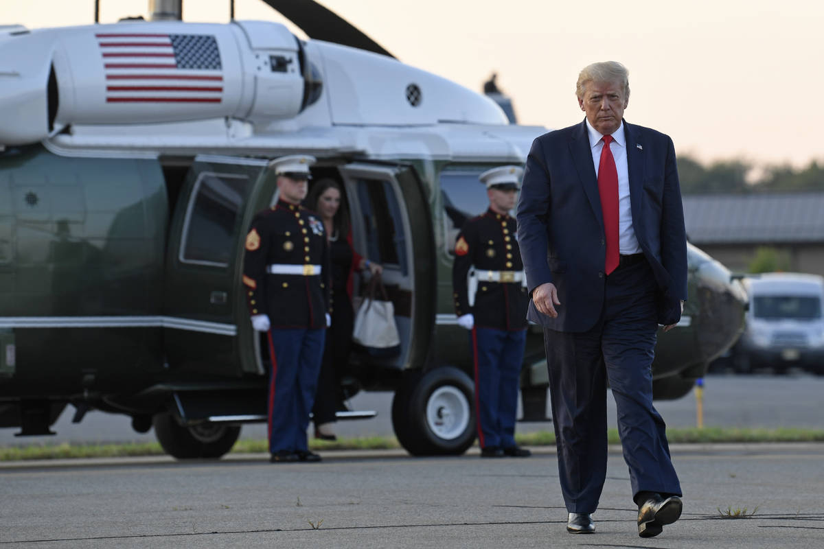 President Donald Trump walks from Marine One and heads over to talk with reporters before depar ...