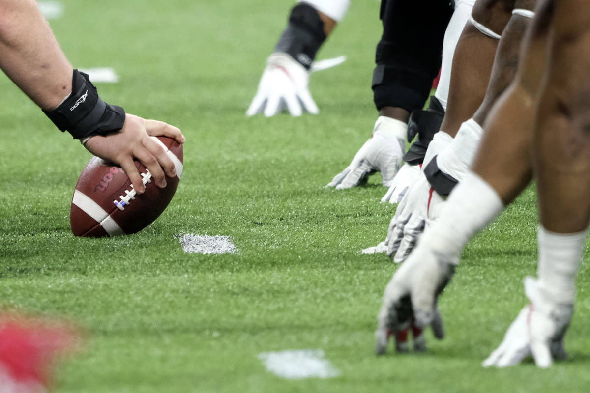 In this Dec. 7, 2019, file photo, a player prepares to hike the ball at the line of scrimmage d ...