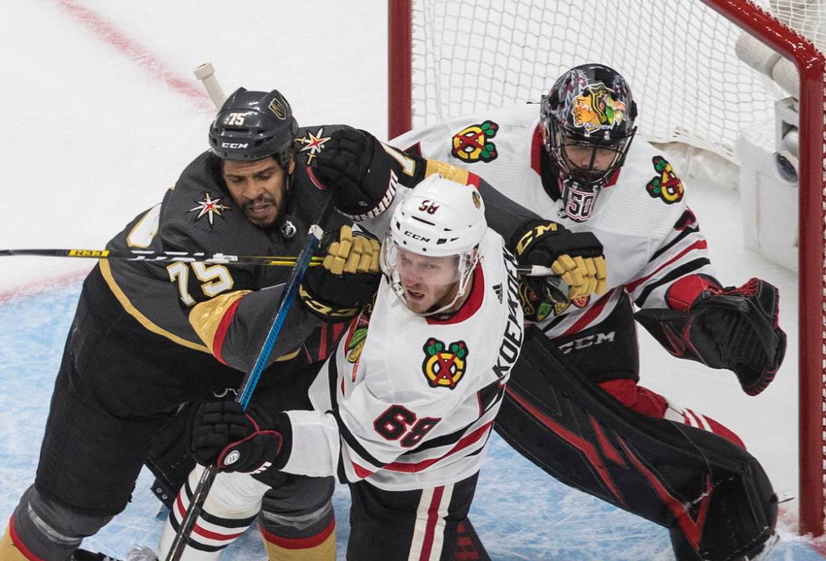 Chicago Blackhawks' Slater Koekkoek (68) and Vegas Golden Knights' Ryan Reaves (75) battle in f ...