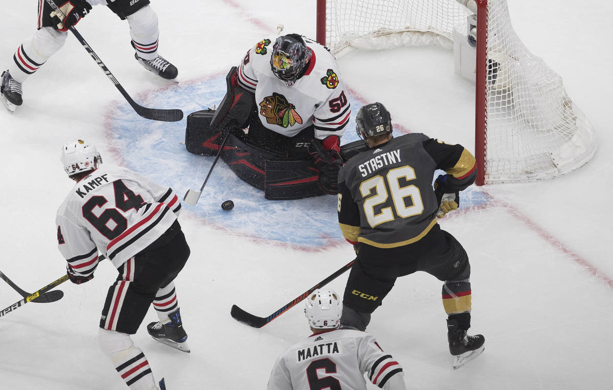 Chicago Blackhawks goalie Corey Crawford (50) makes the save on Vegas Golden Knights' Paul Stas ...