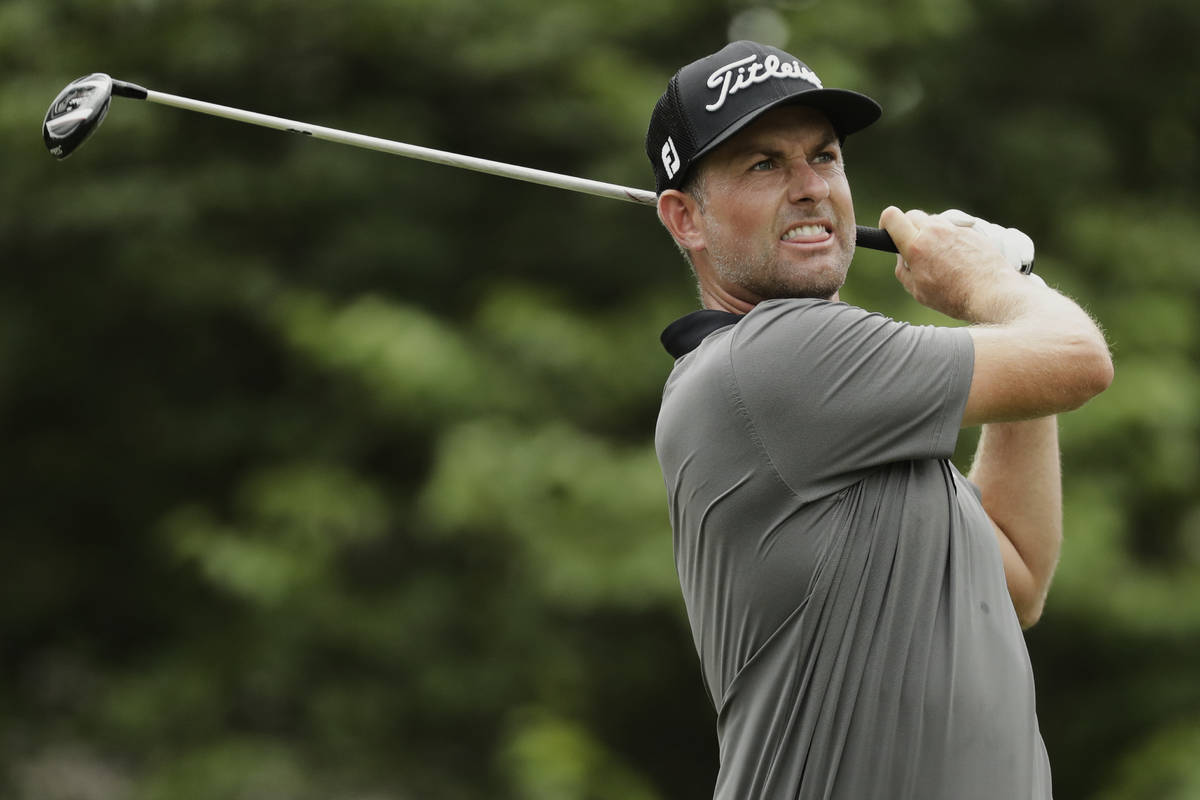 Webb Simpson watches his tee shot on the 18th hole during the first round of the World Golf Cha ...