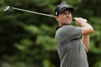 Webb Simpson watches his tee shot on the 18th hole during the first round of the World Golf Cha ...