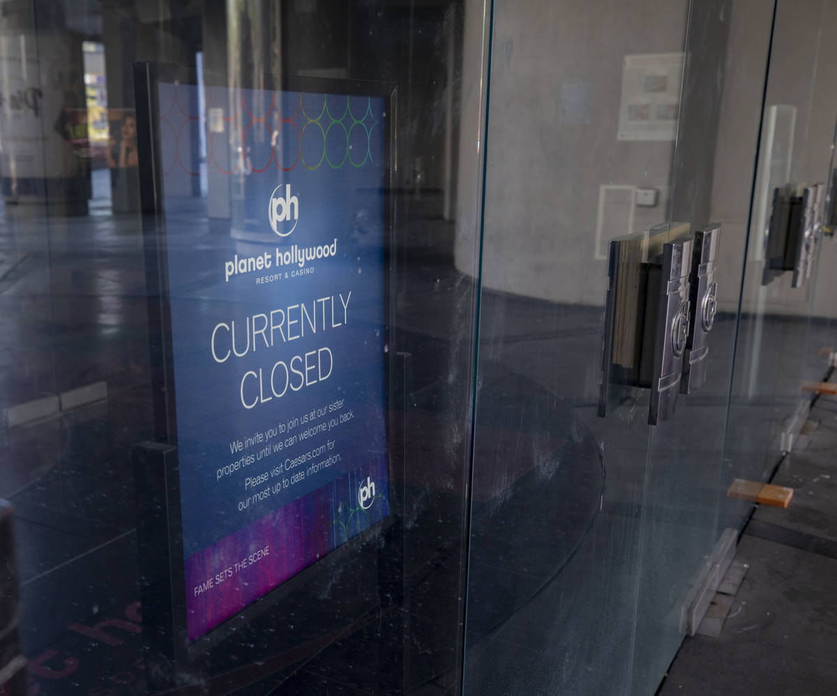 A sign stating Planet Hollywood's temporary closure is seen inside the doors of the hotel-casin ...