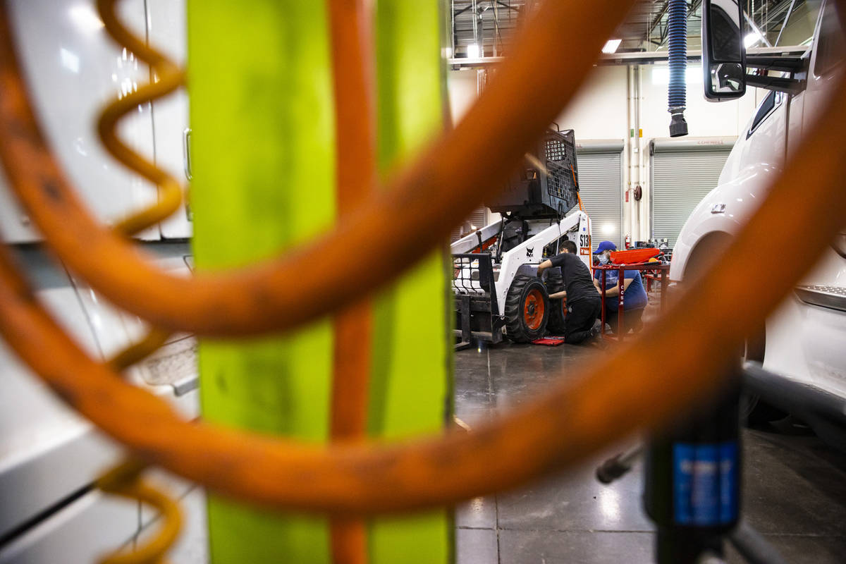 Students work on repairing a Bobcat utility vehicle during a diesel hydraulics class at the Col ...