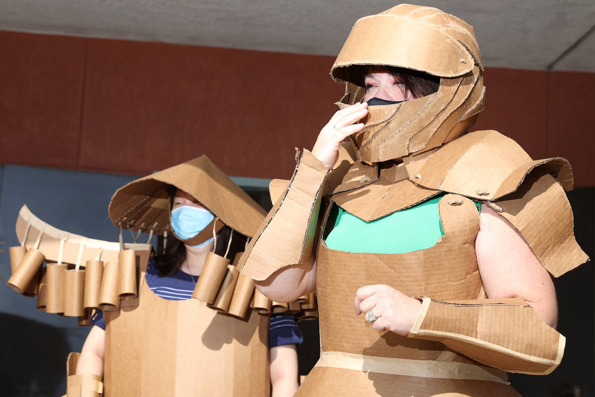 Jessica Yi, left, and Anne Savage, model their cardboard costumes during their class at UNLV in ...