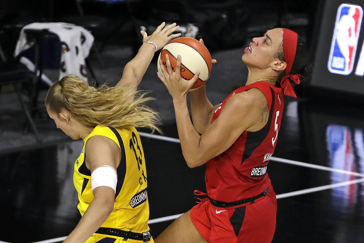 Las Vegas Aces forward Dearica Hamby (5) scores in front of Indiana Fever forward Lauren Cox (1 ...