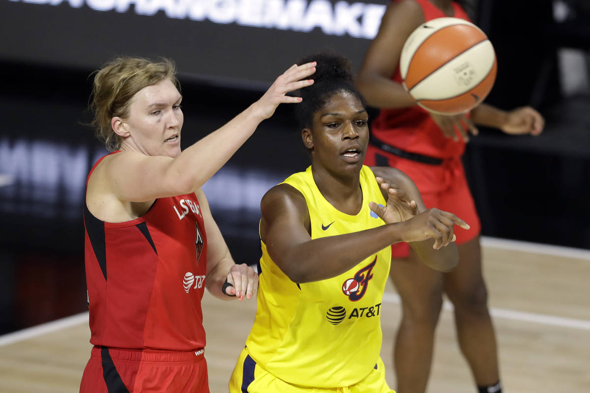 Indiana Fever center Teaira McCowan (15) pases the ball in front of Las Vegas Aces center Carol ...