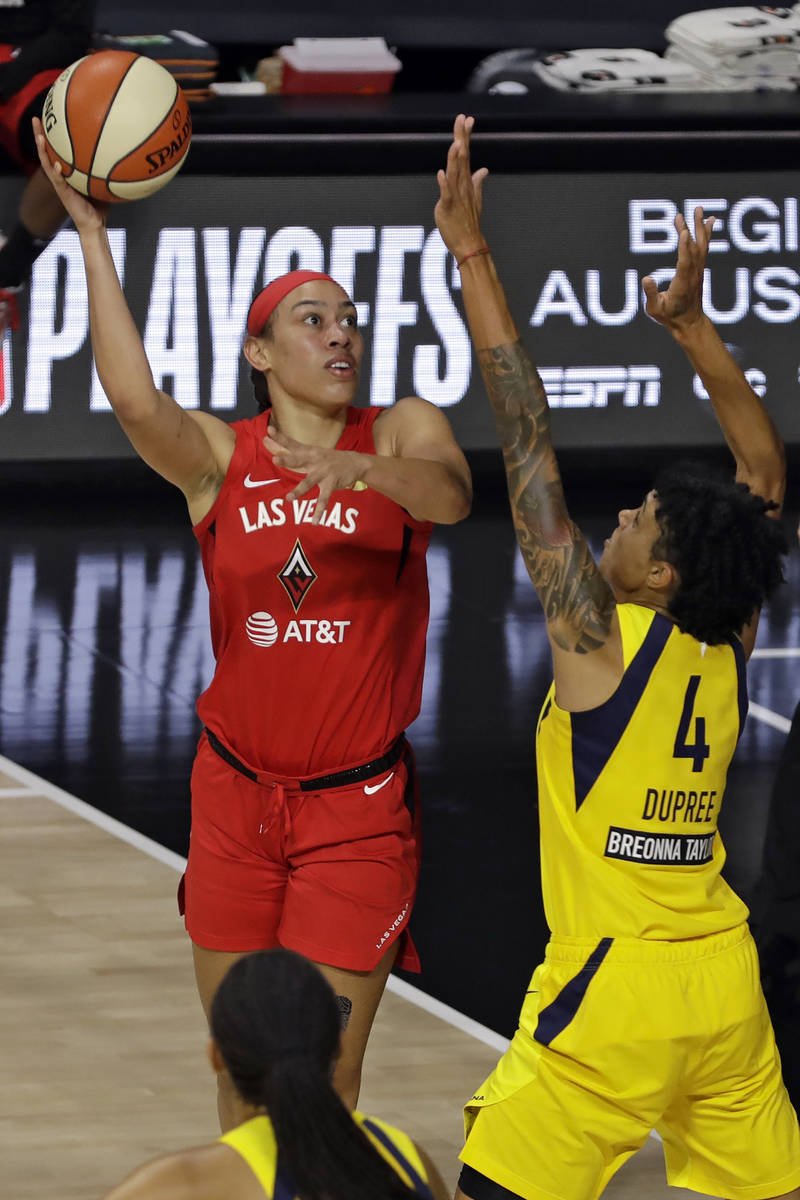 Las Vegas Aces forward Dearica Hamby (5) shoots over Indiana Fever forward Candice Dupree (4) d ...