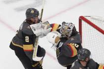 Vegas Golden Knights goalie Robin Lehner (90) makes a save as Zach Whitecloud (2) defends durin ...