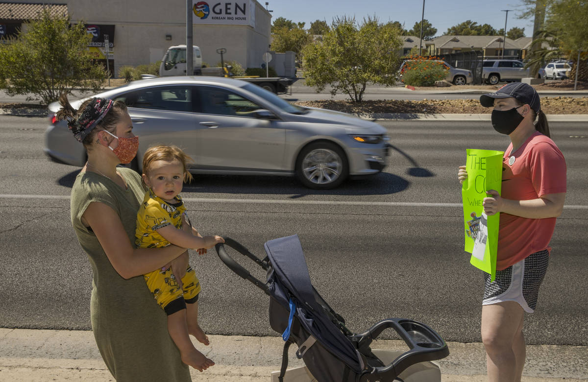 Esther Johnson, left, with son Eli Yosef, 1, stand with Diana Battista outside the County Schoo ...