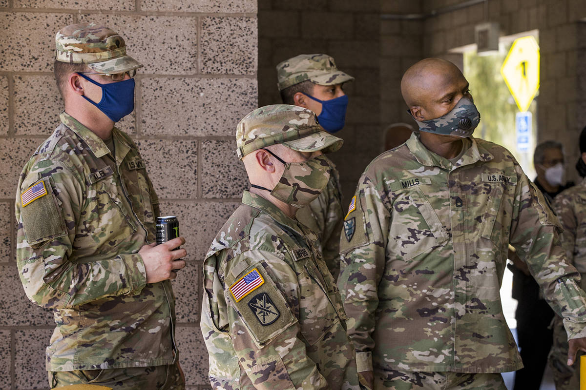 Nevada National Guard troops listen in during the Clark County media briefing and walk through ...