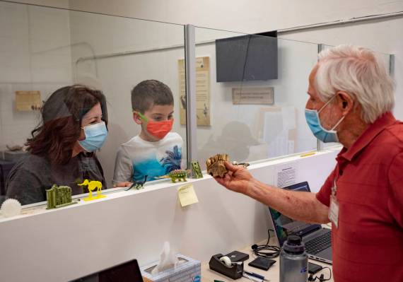 Museum attendees Tara Shiroff, left, and Alex Shiroff, 7, of Las Vegas, and Steve Rowland, pale ...