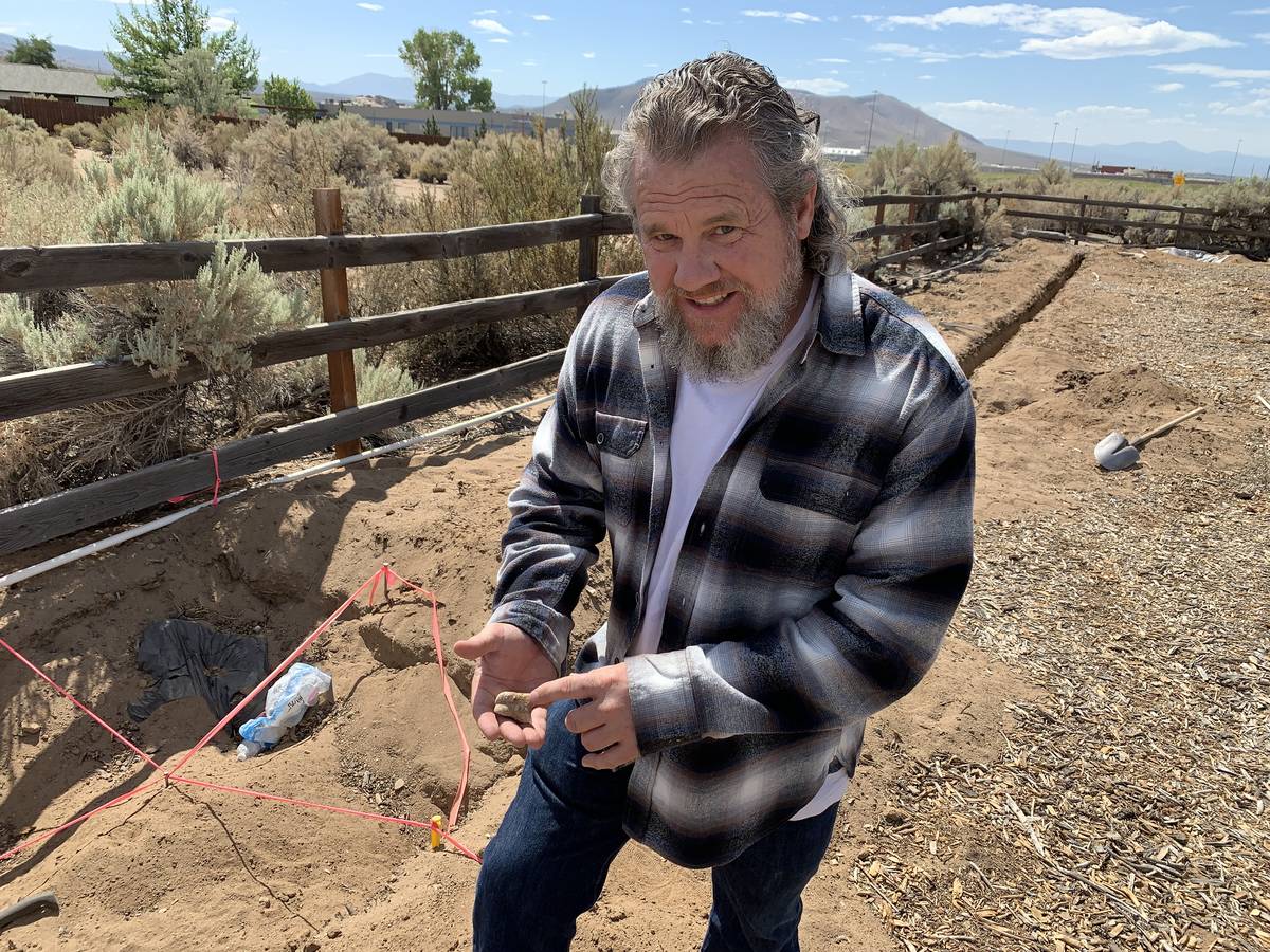 Tom Gordon holds a fossilized toe bone from an unidentified species that he found on his proper ...