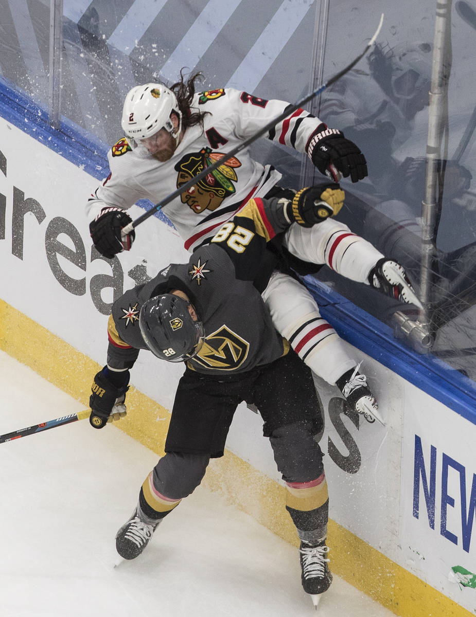 Chicago Blackhawks' Duncan Keith (2) is checked by Vegas Golden Knights' William Carrier (28) d ...
