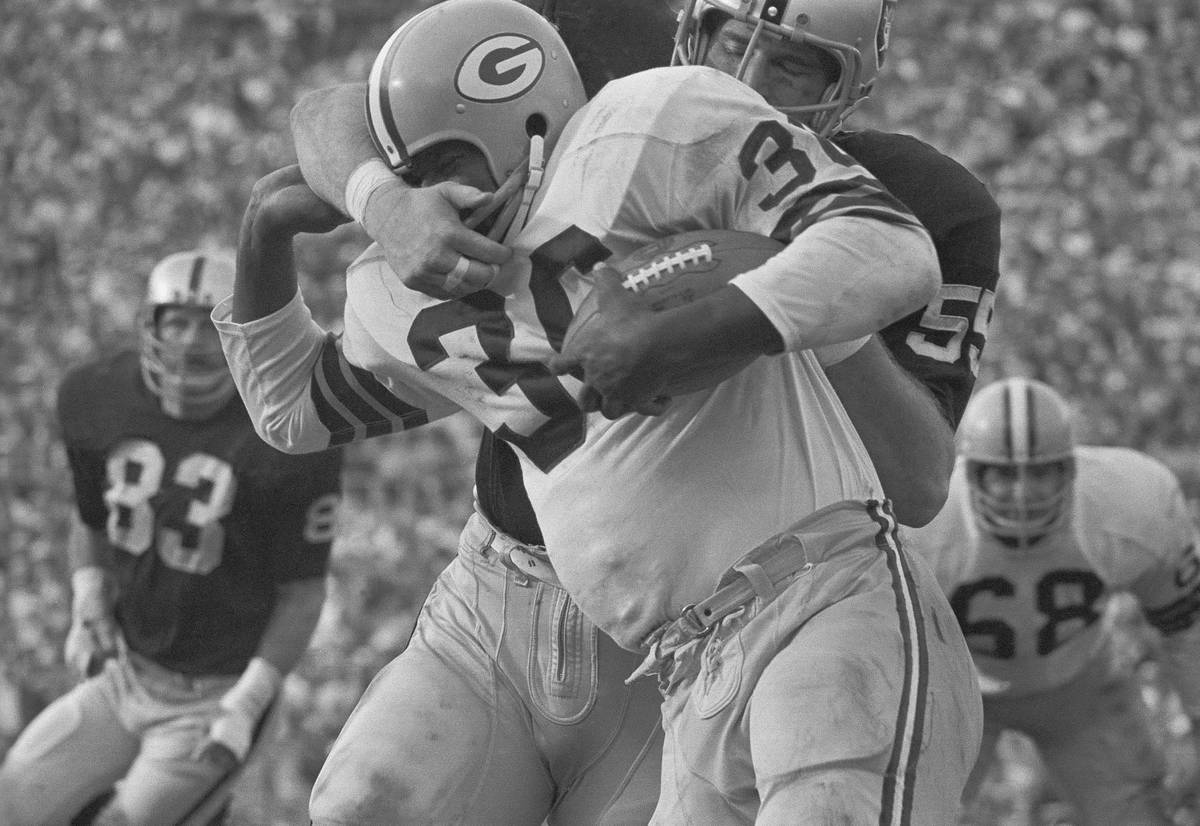Green Bay Packers back Ben Wilson (36) tries to get free from a face mask grab by Oakland lineb ...