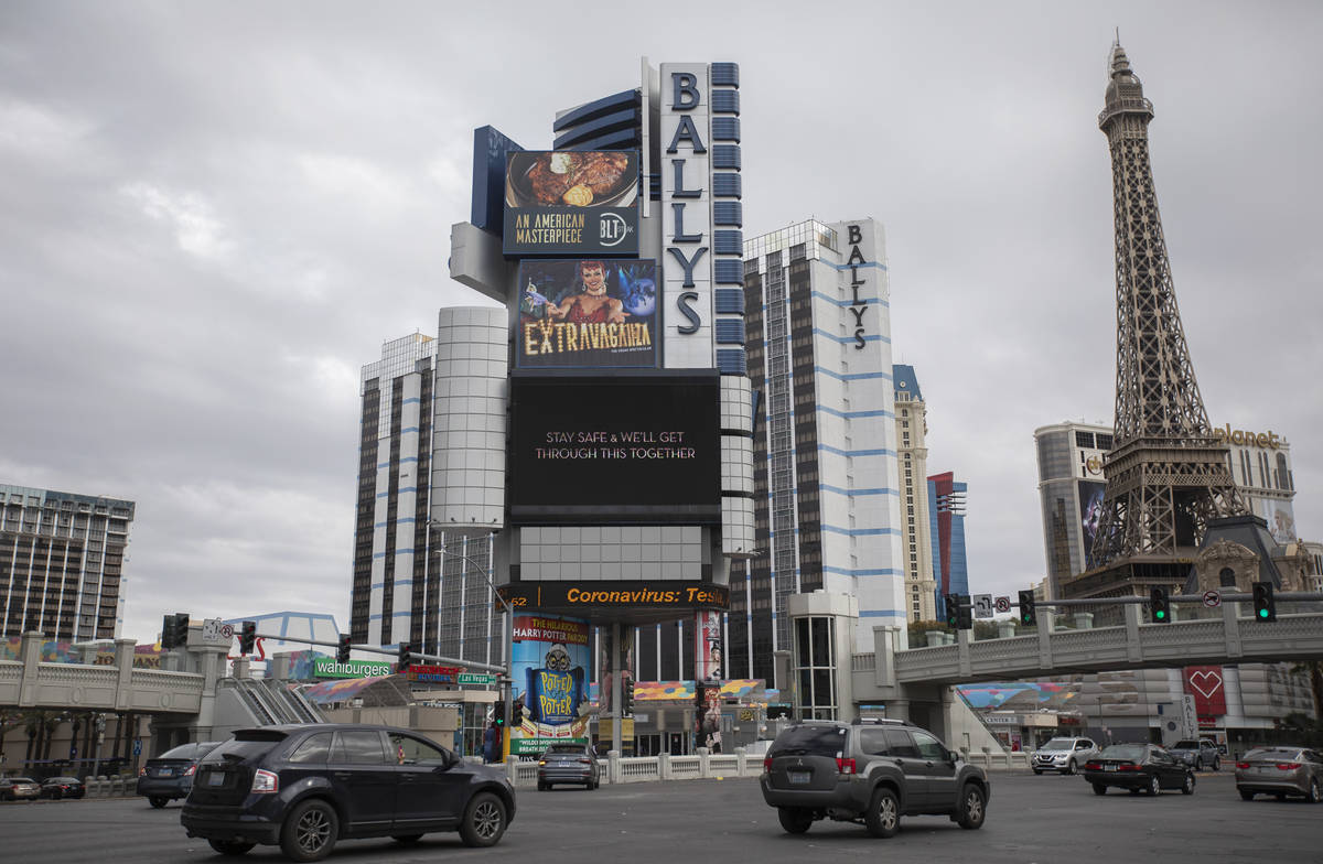 The Bally's marquee shows MGM's message alongside news about coronavirus on the Strip on Wednes ...